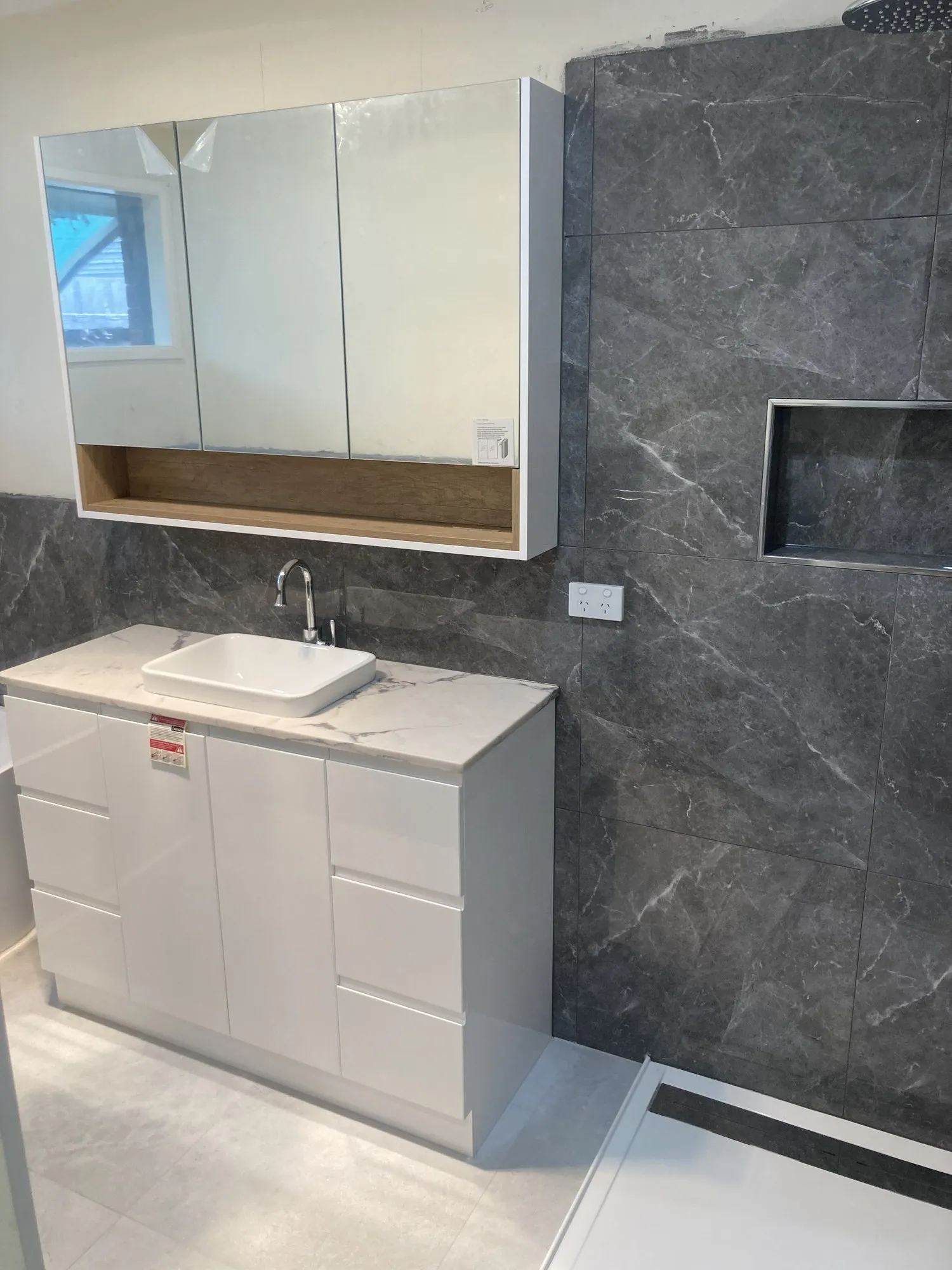 A stone feature-wall bathroom completed by Sheldon Harvey